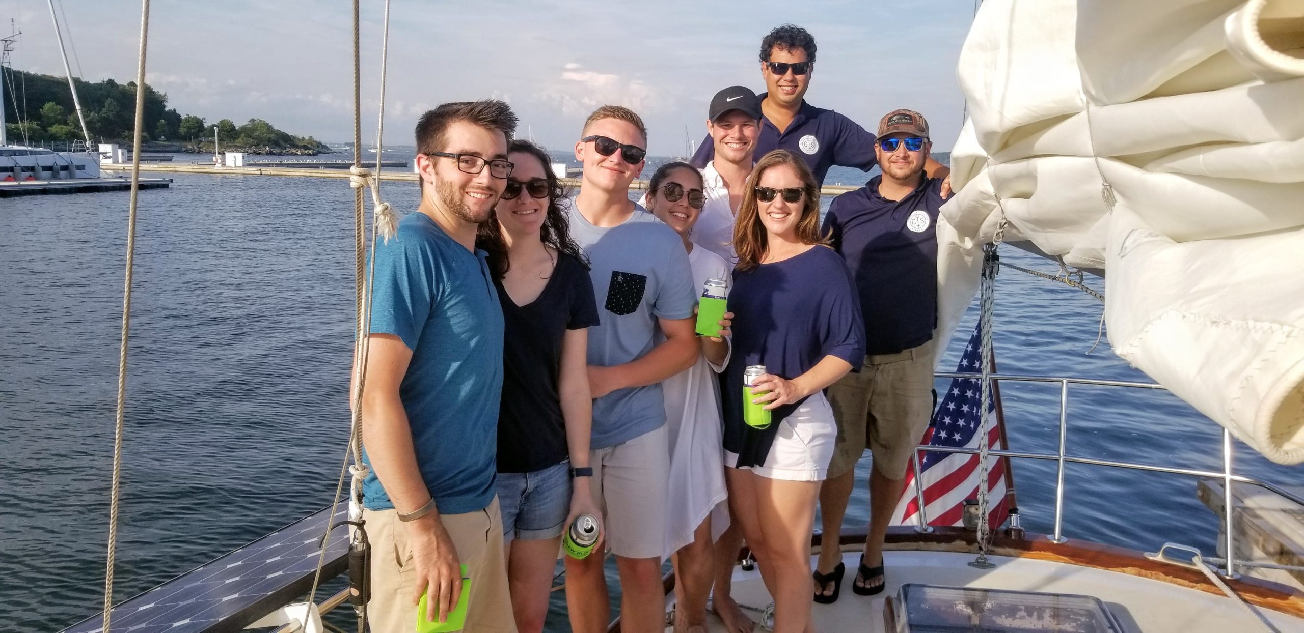 a group of people standing on a boat posing for the camera