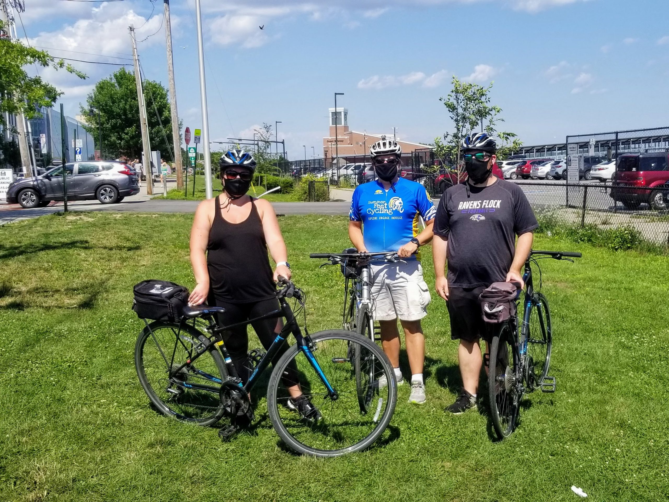 a group of people standing next to a bicycle