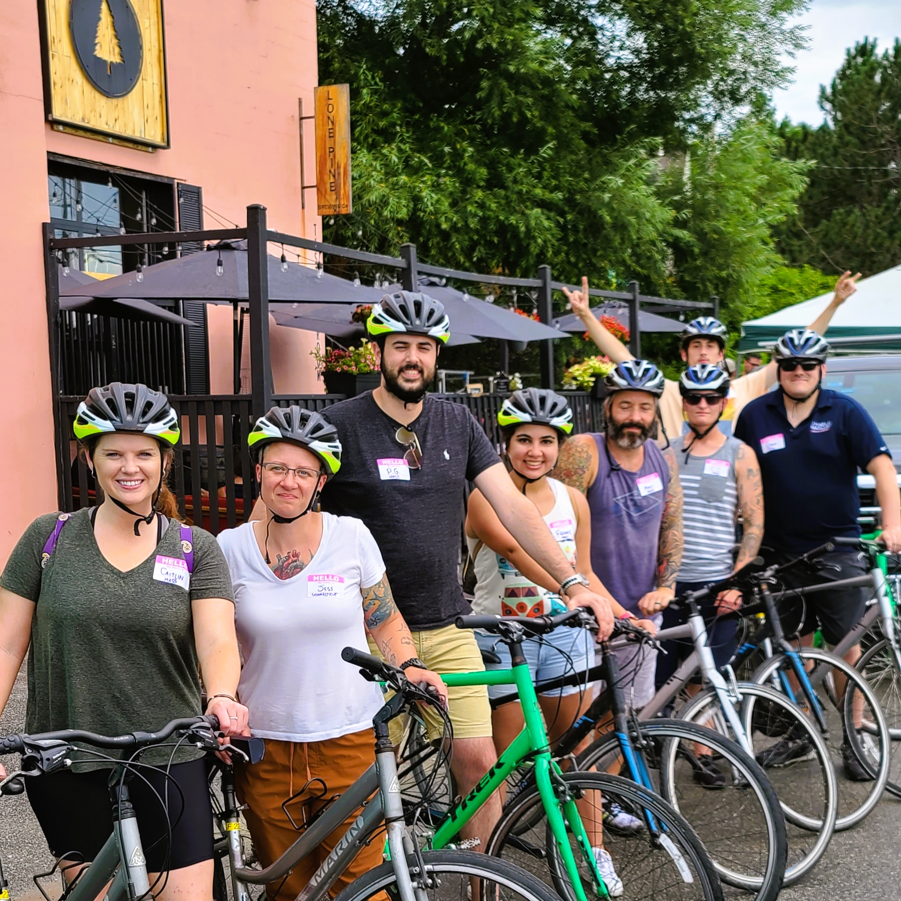 a group of people standing next to a bicycle