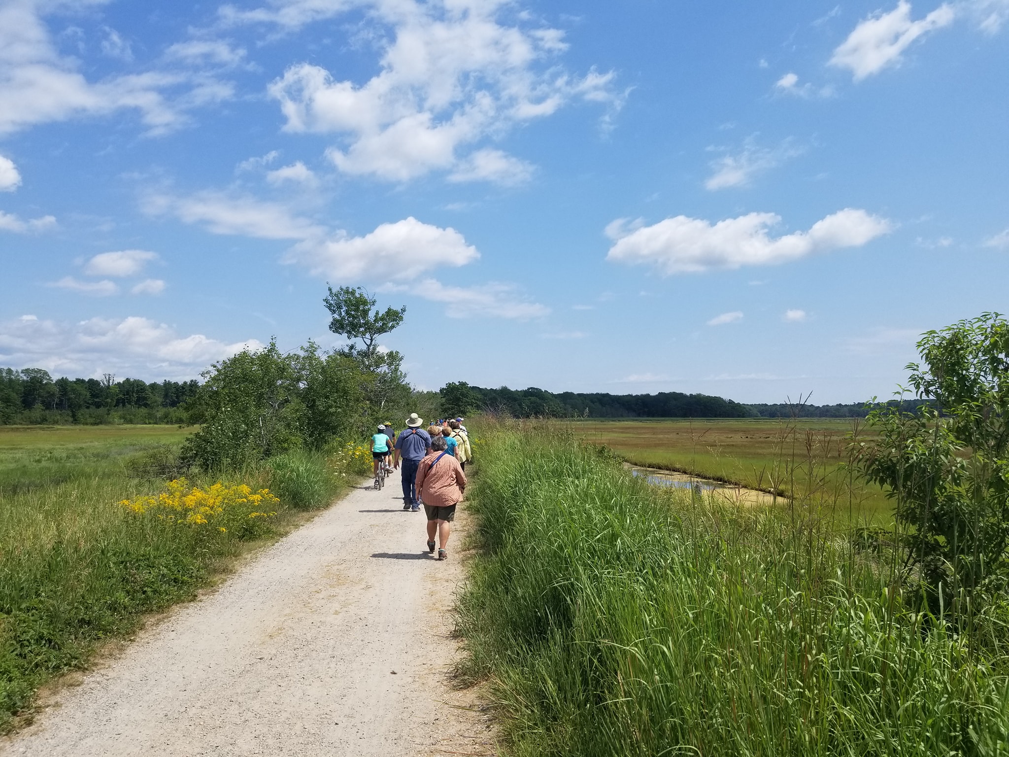 a man riding a motorcycle down a dirt road