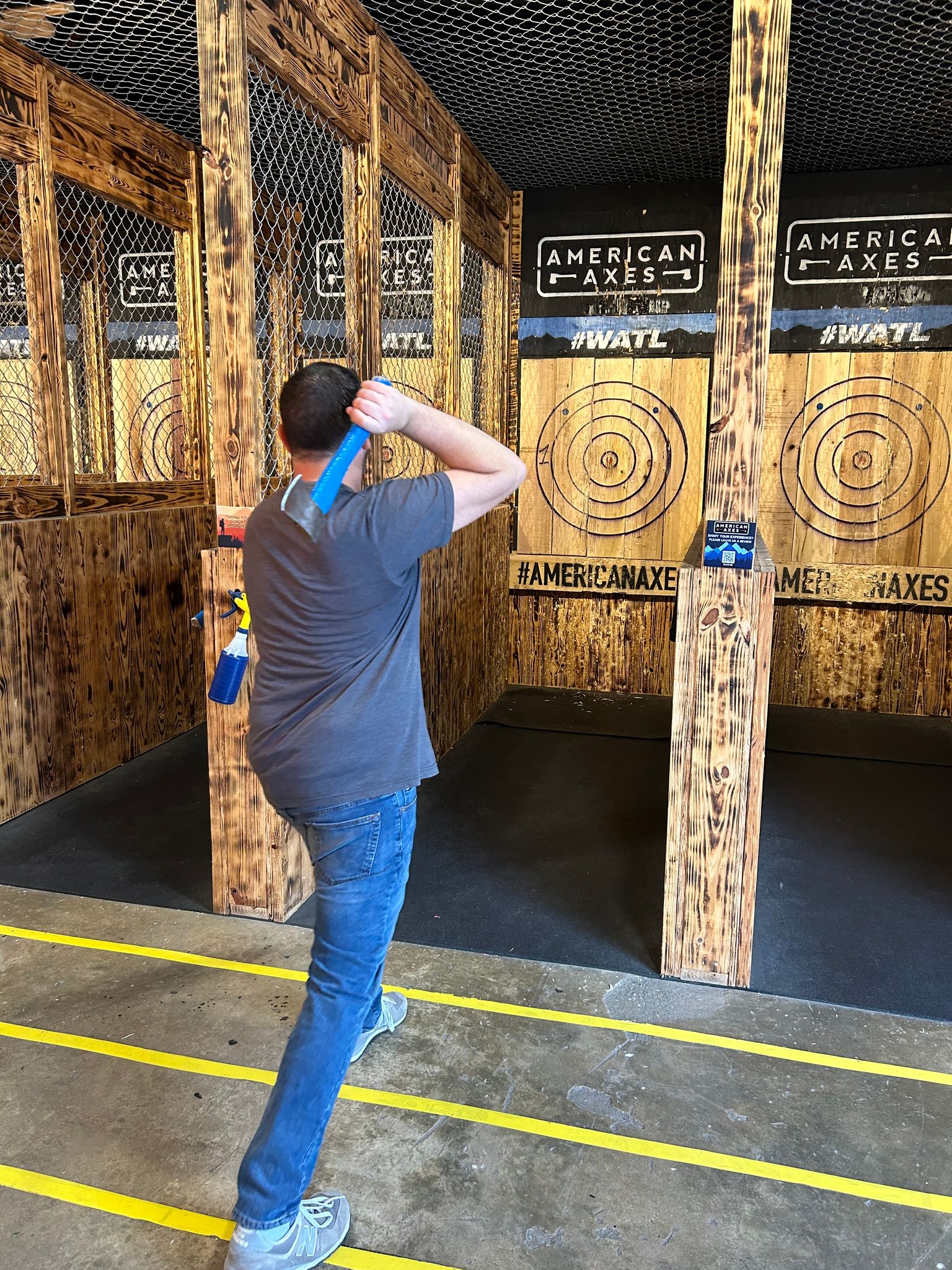 man throwing axes at american axes