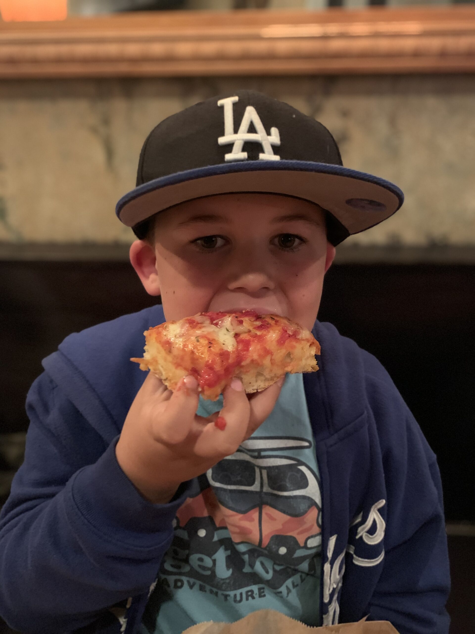kid eating pizza