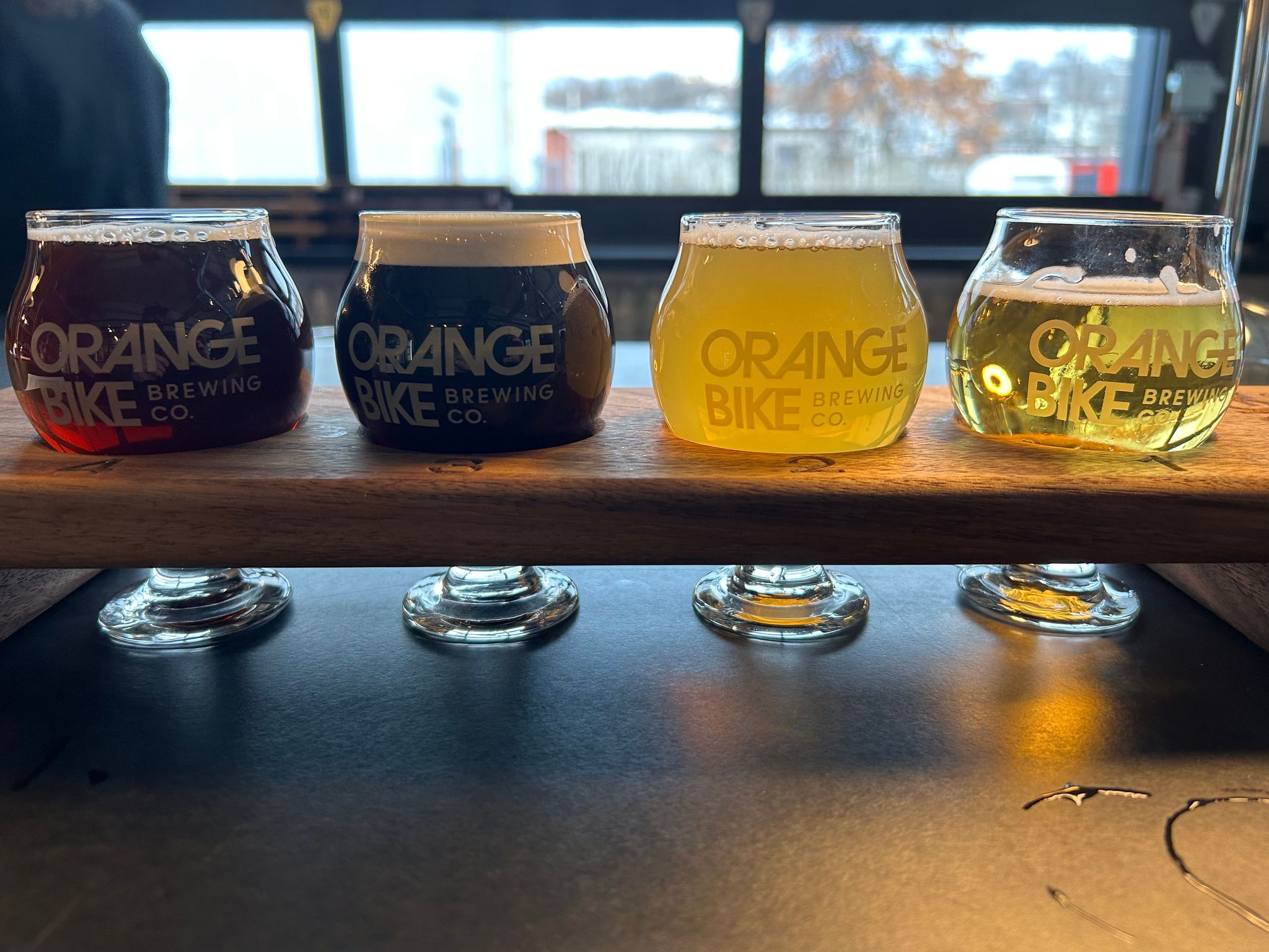 beer flight tasting orange bike brewery